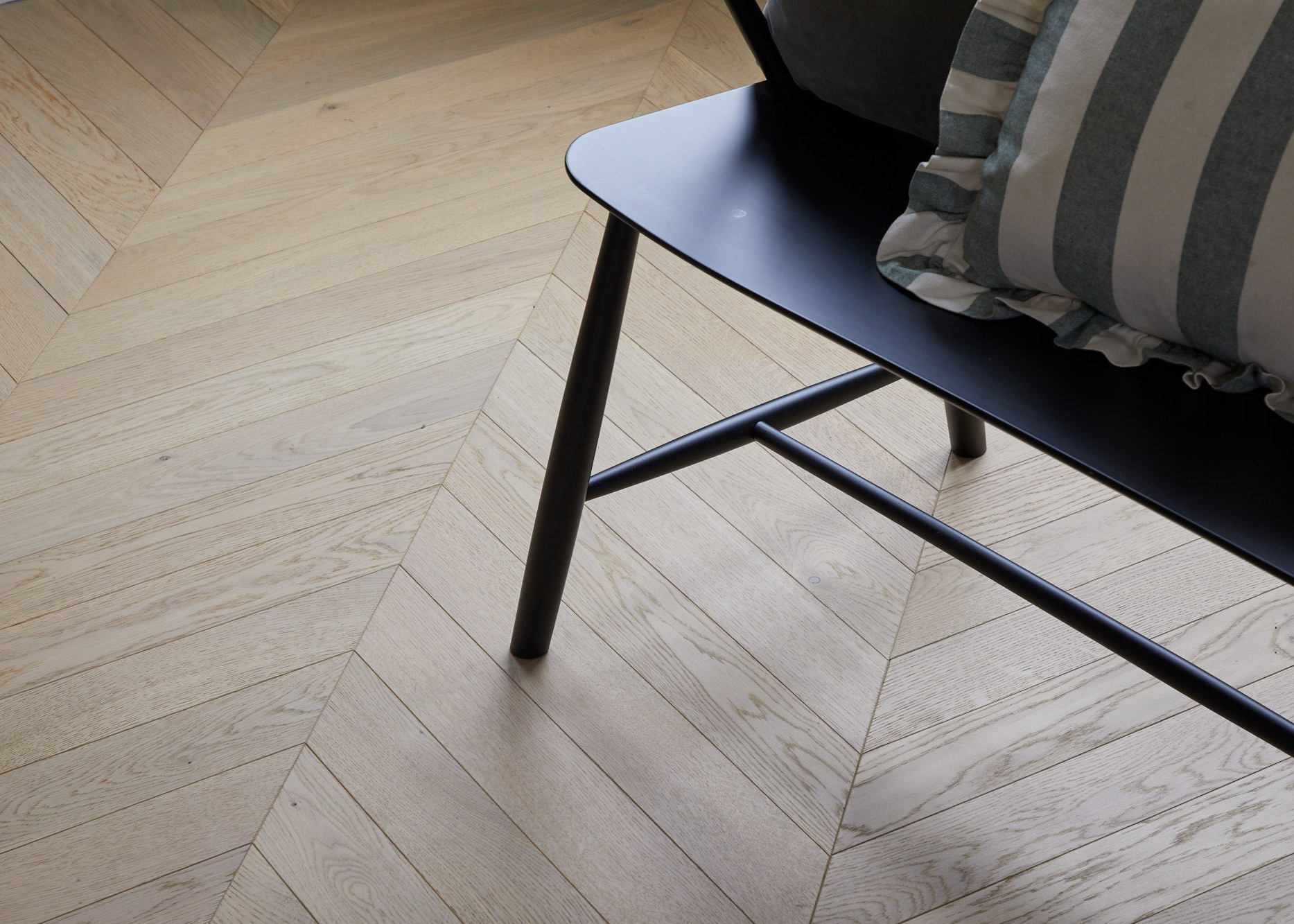 close-up of chair on chevron wood flooring