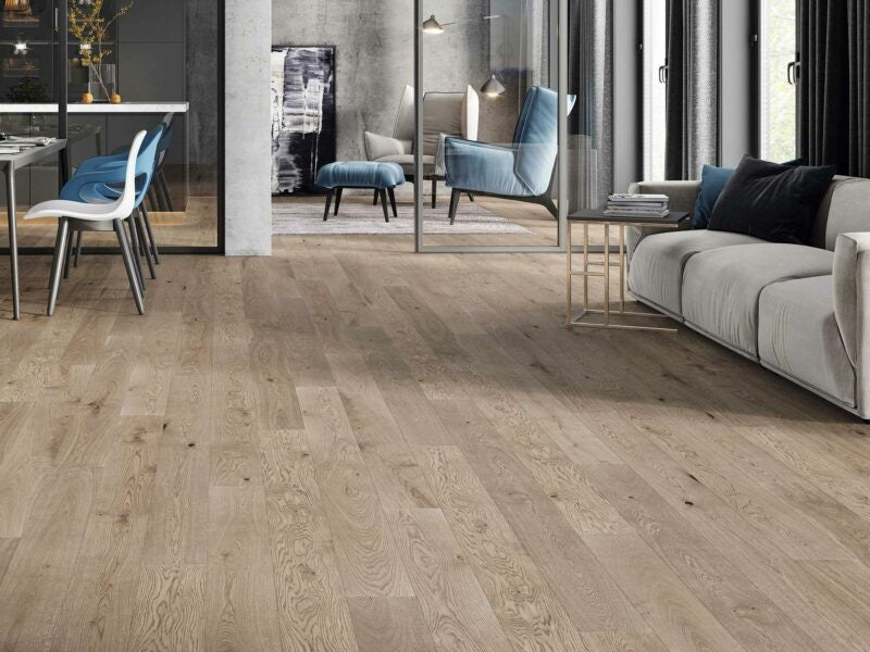 Living room with Driftwood Pebble Grey wooden flooring, sofa, and chairs.