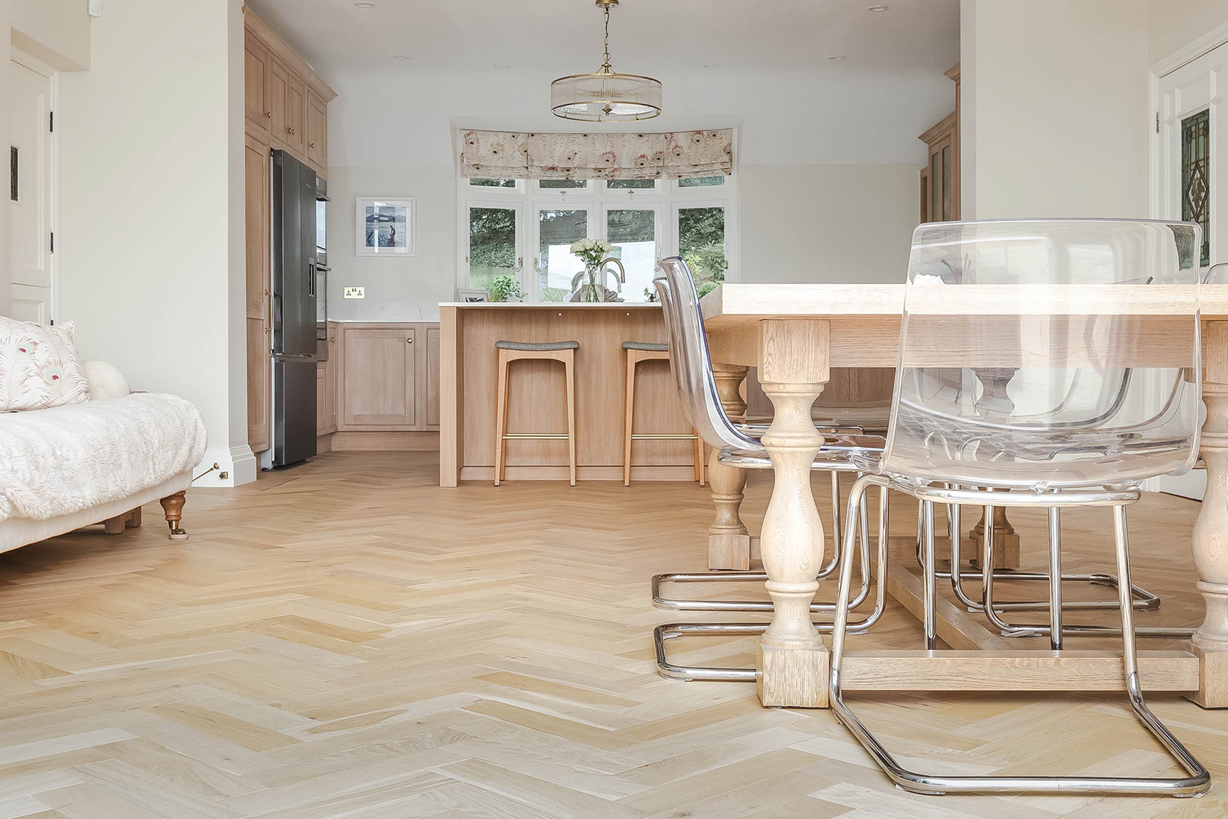 light shore drift oak herringbone in open plan kitchen with bespoke wood cabinetry