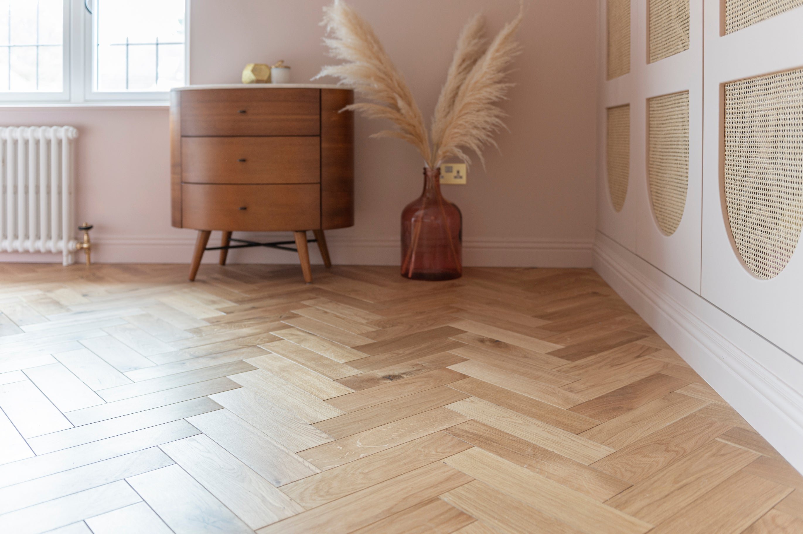 oiled wood floor in a blush pink bedroom