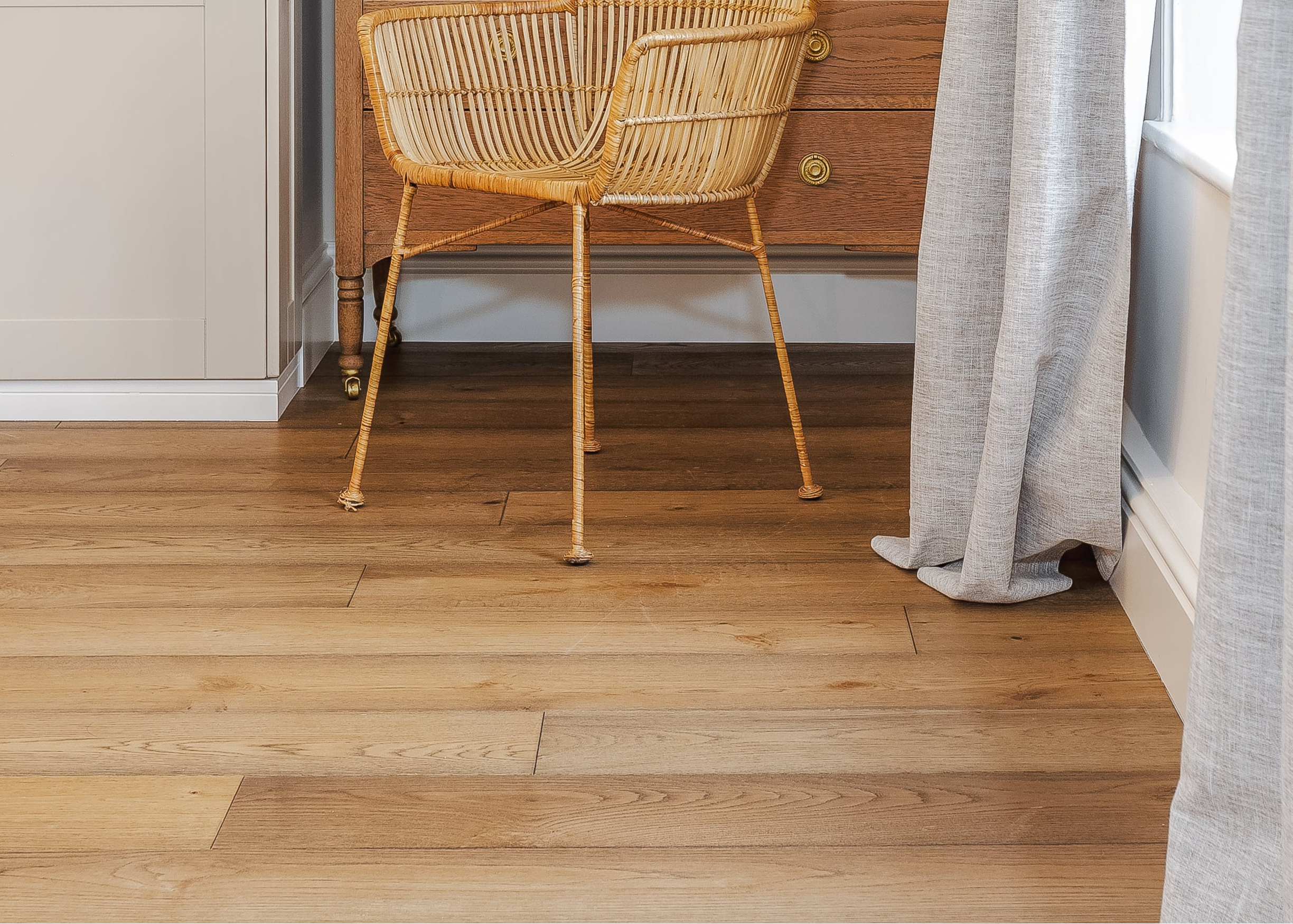 heritage wood floor close up with grey curtains and wood chair
