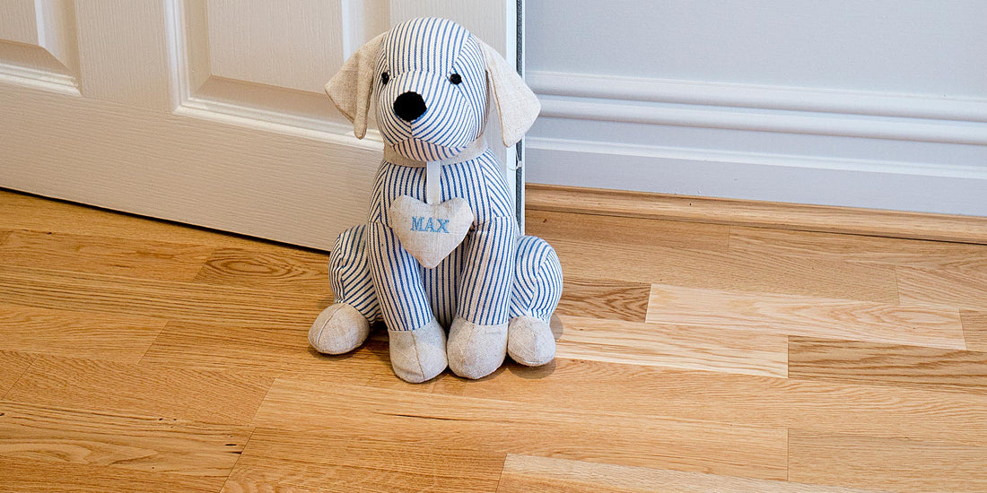 dog door stop sitting on three strip wood flooring