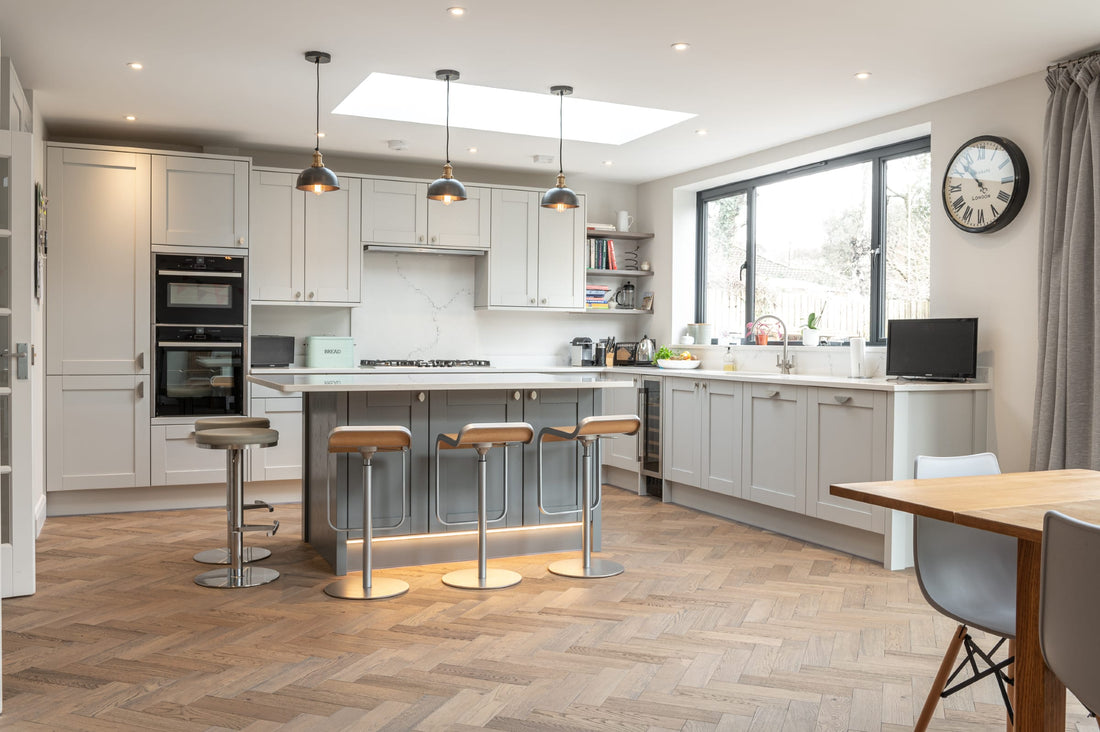 A perfect combination. Shaker kitchen design and herringbone wood floors.