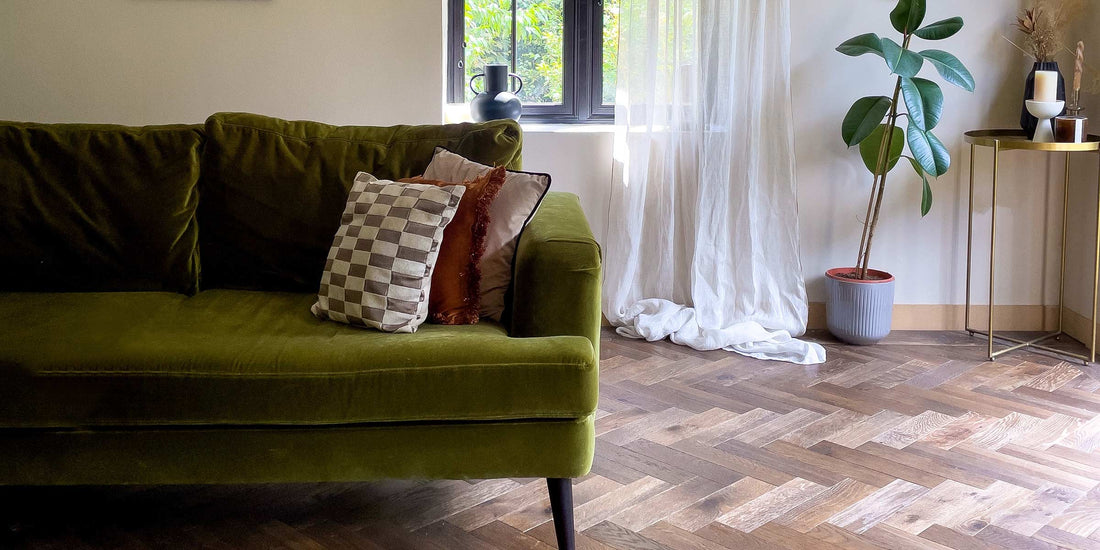 green velvet soft in living room with parquet floors