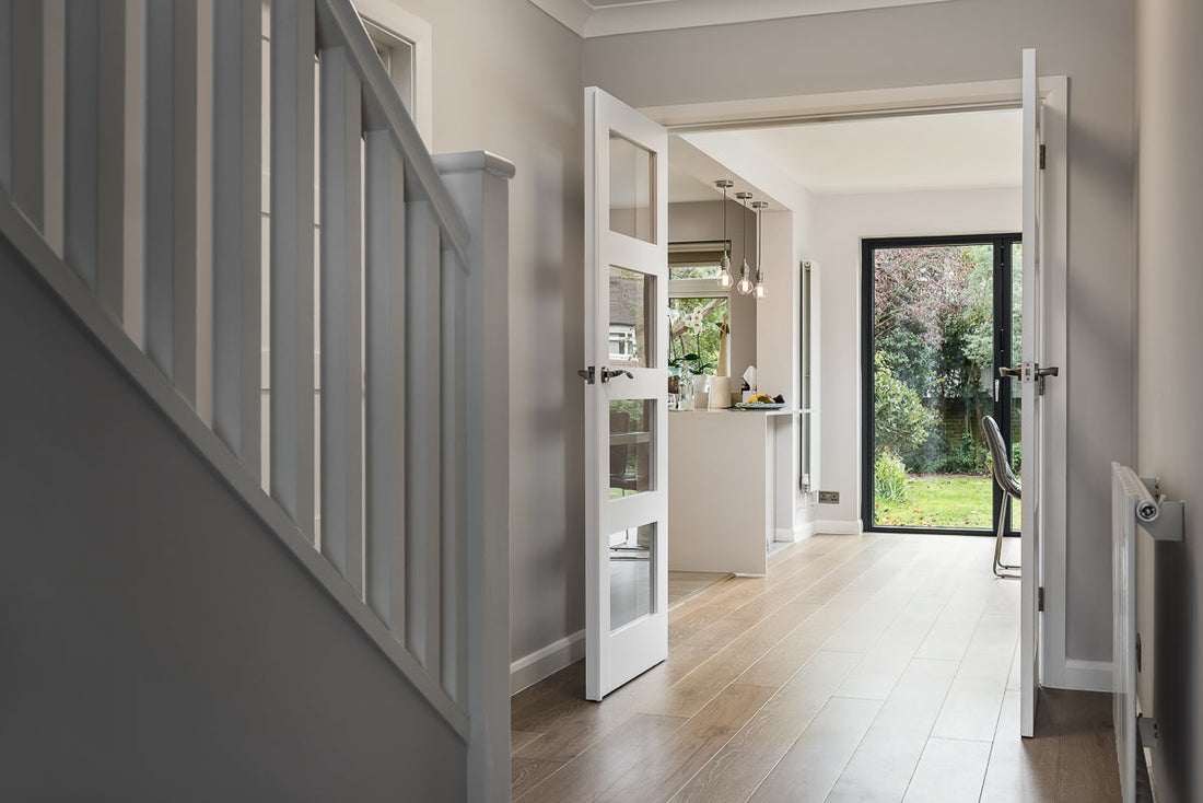 light wood floor in modern hallway with timber stairs