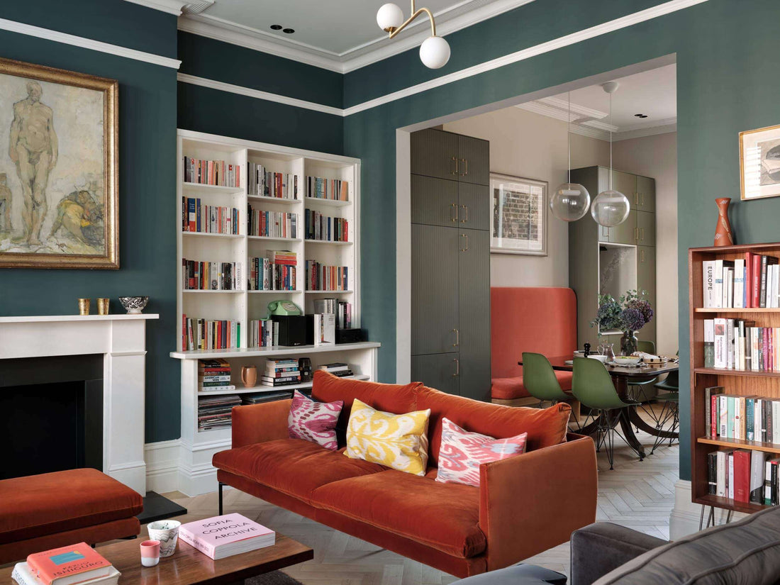 a room with a bold colour scheme and oak wood flooring