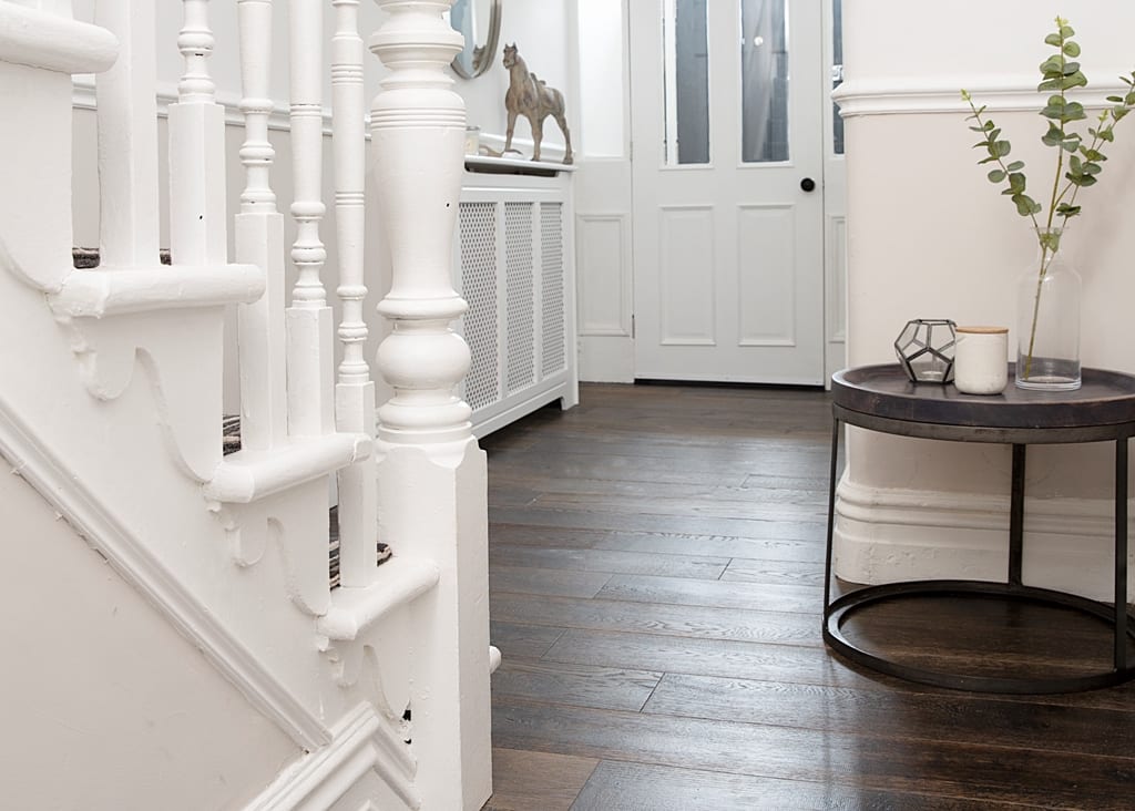Create a natural welcome in your home. Real wood floors in hallway design