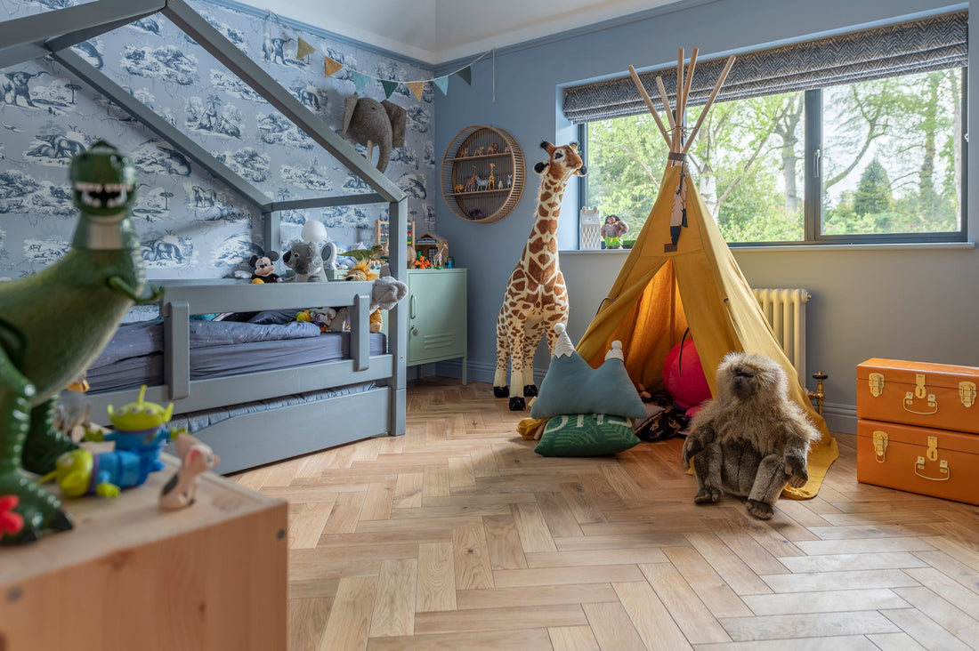 jungle themed blue bedroom with oak herringbone flooring