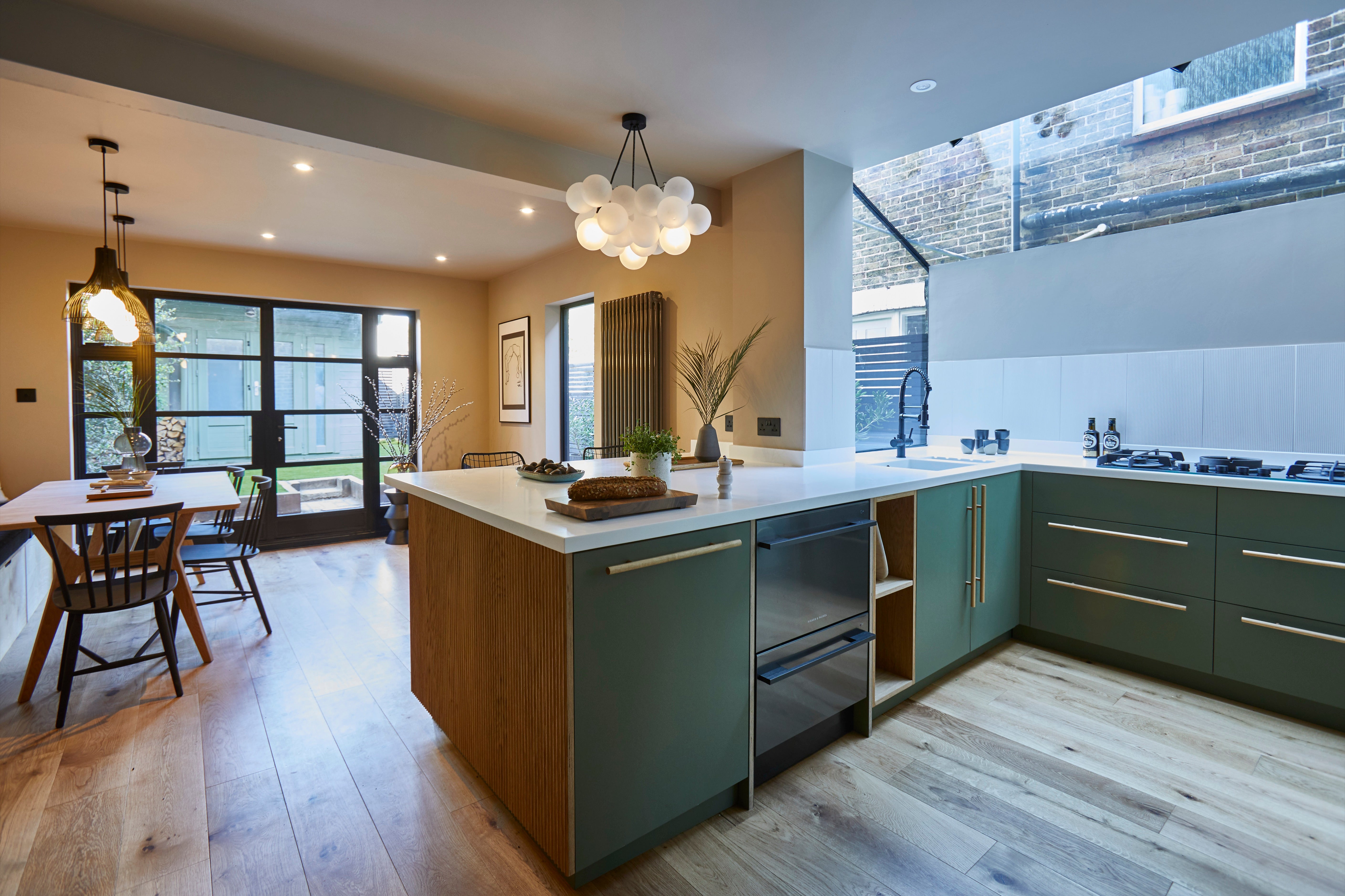 Alpine Glade Oak in an open plan green kitchen