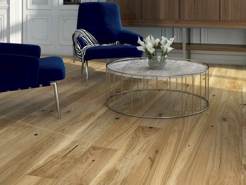 Modern living room with blue chairs and a round glass coffee table on Driftwood brushed oak wood floors