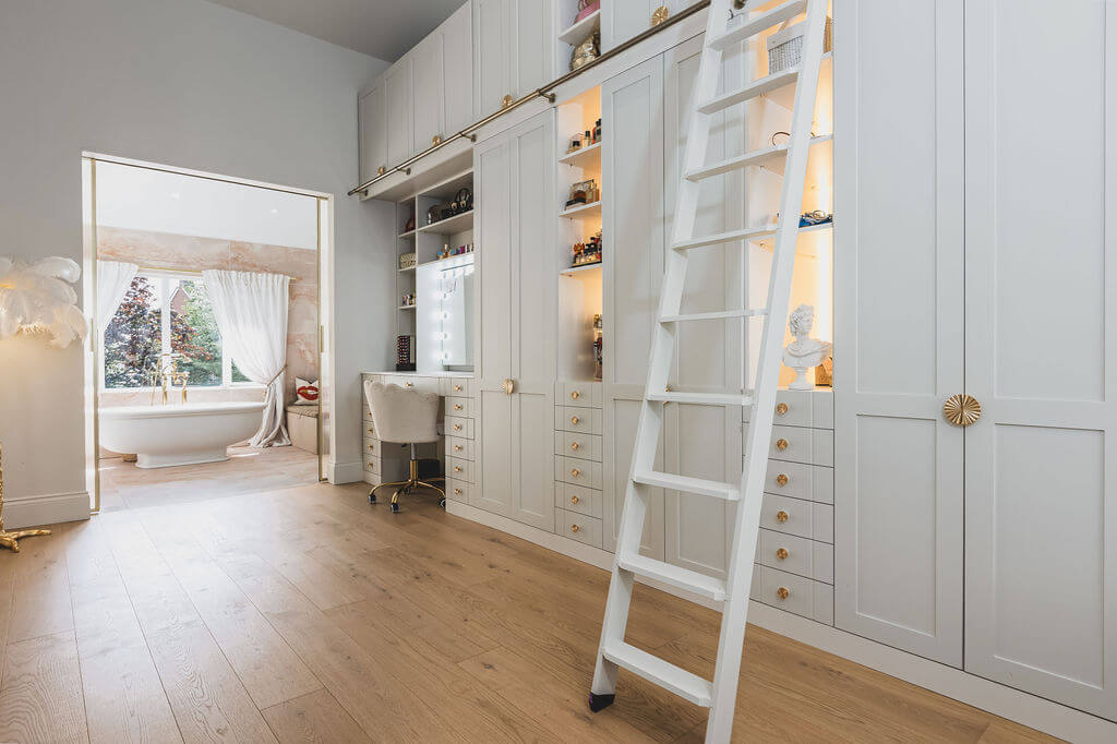 Bedroom with Tundra Seashell oak planks leading into a bathroom