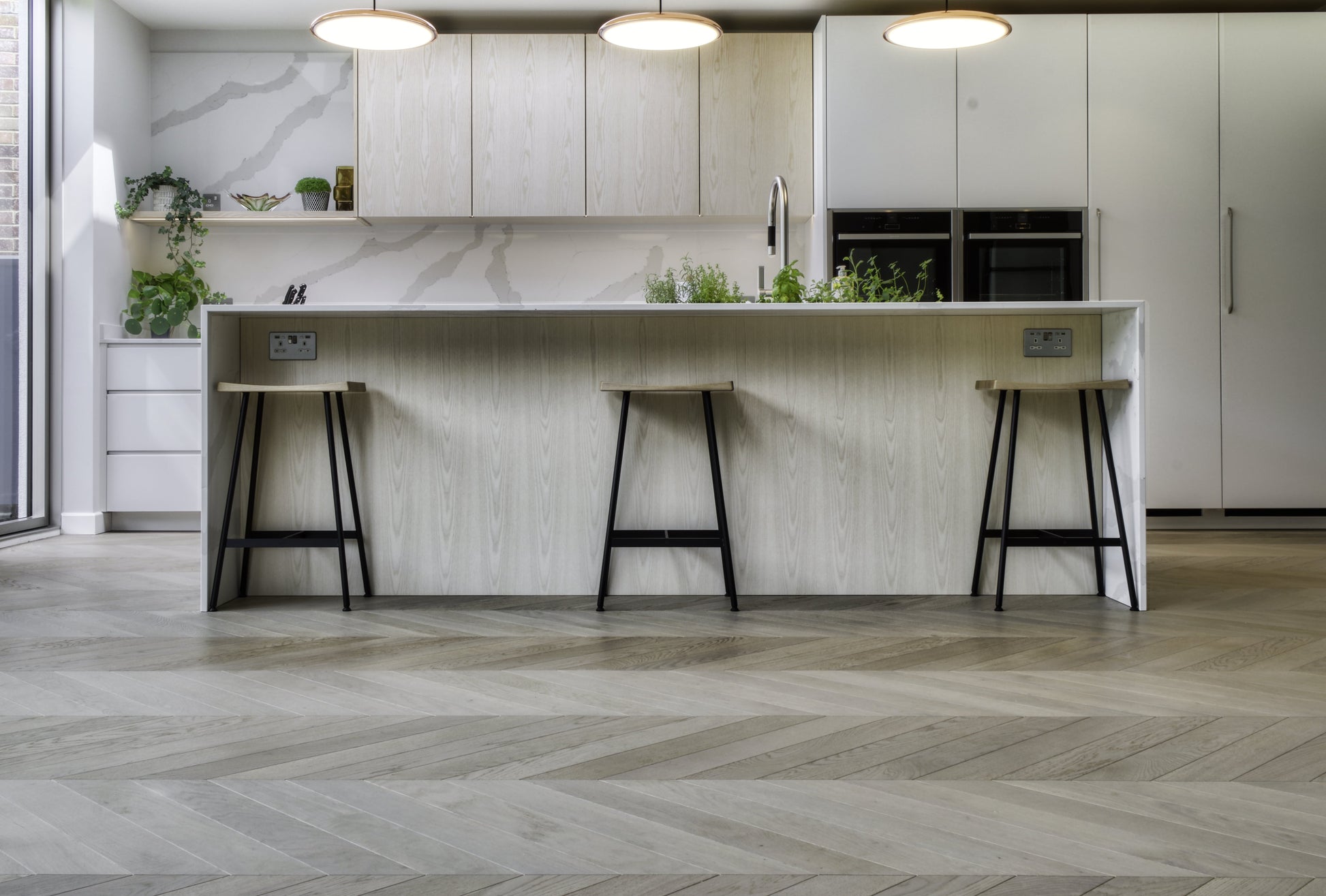Misty Grey chevron is a modern kitchen with white marble countertops