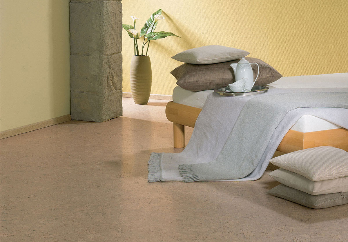 Bedroom with light muted cork flooring