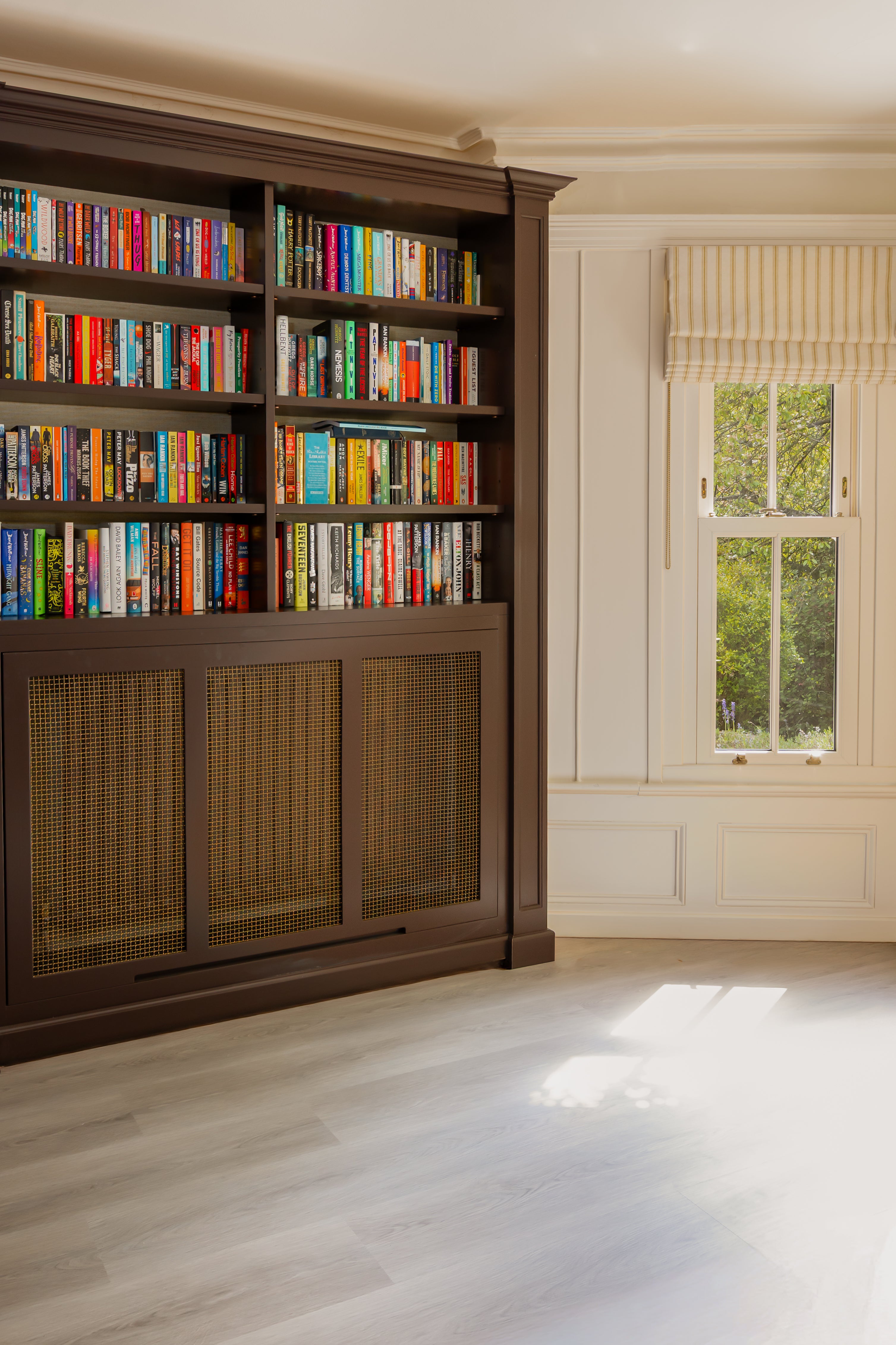 a light toned spc click vinyl floor installed in a room with feature bookshelves