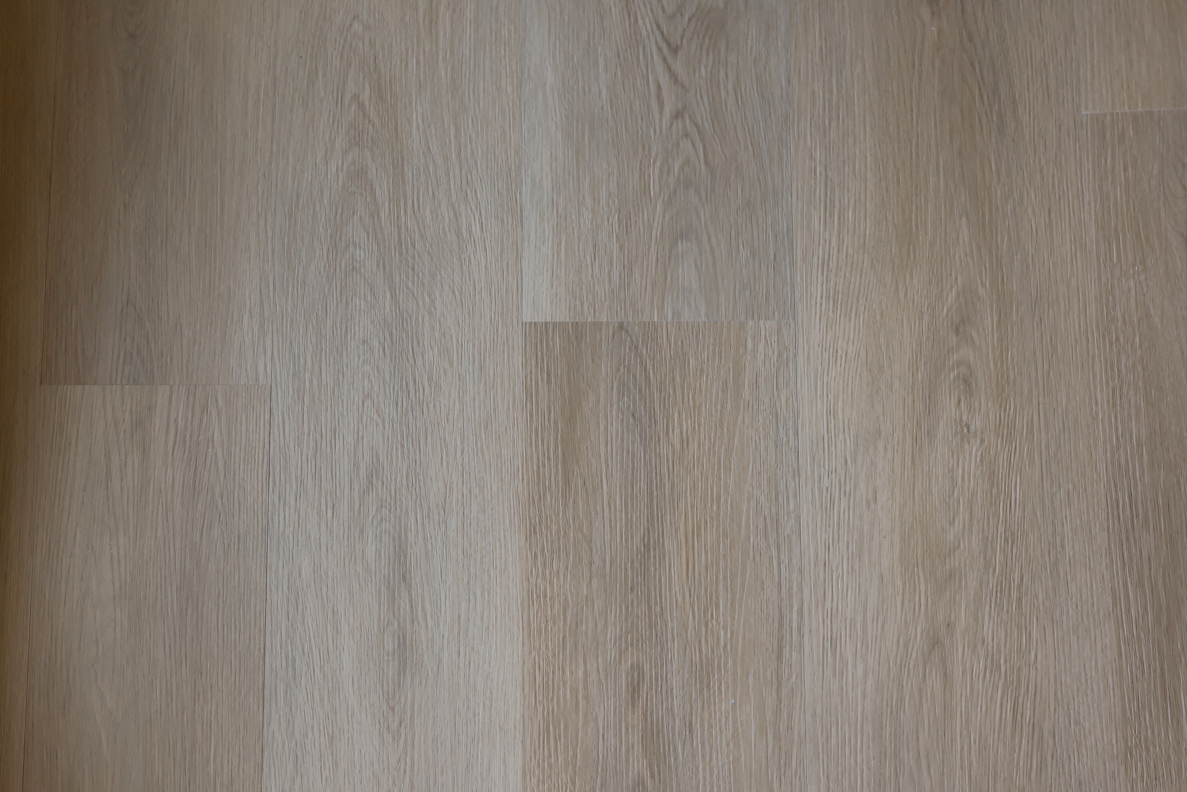 Close-up of a modern click vinyl SPC floor with a neutral color palette