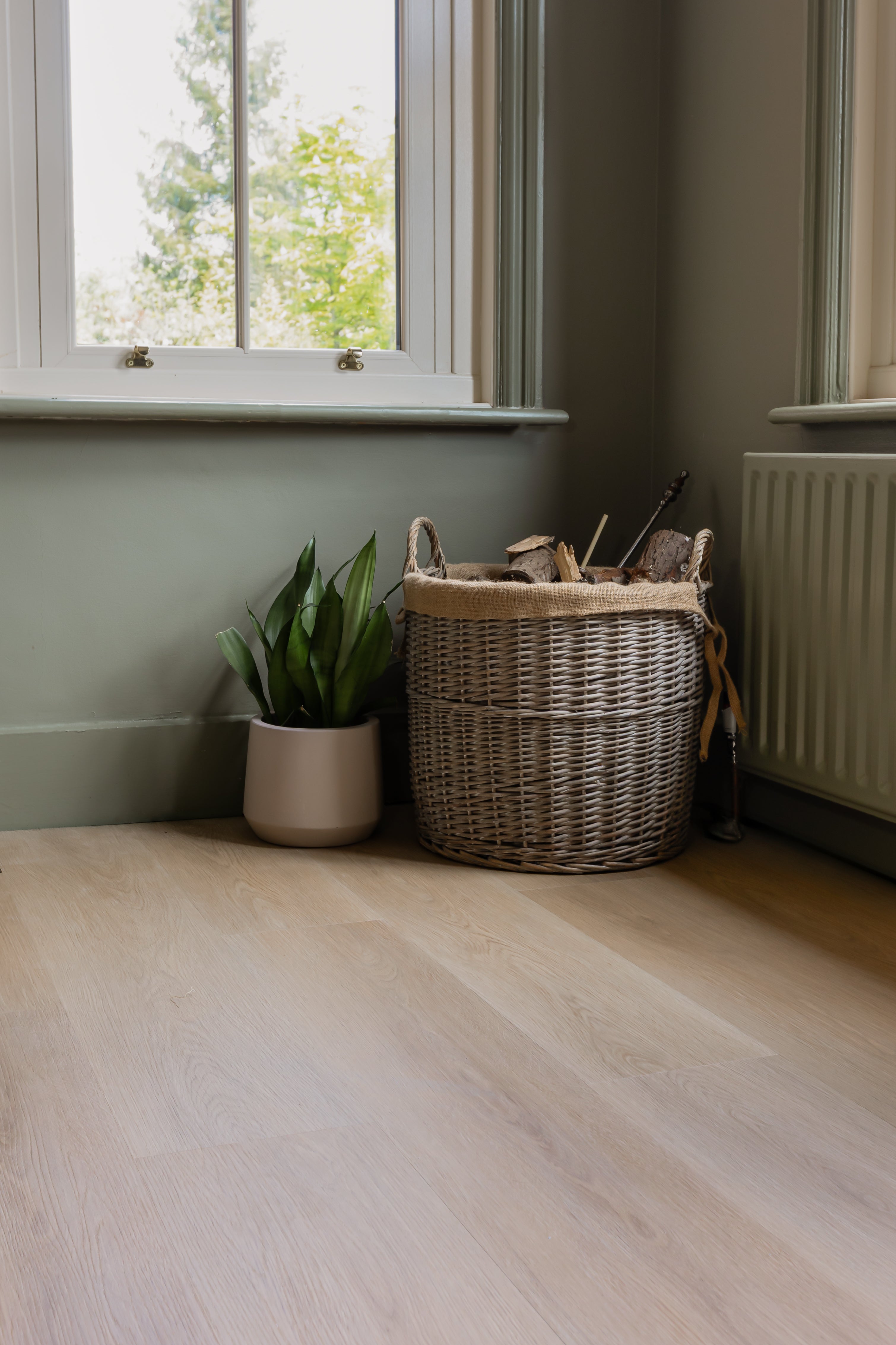 Basket on top of a light brown and grey SPC vinyl floor with rustic grains
