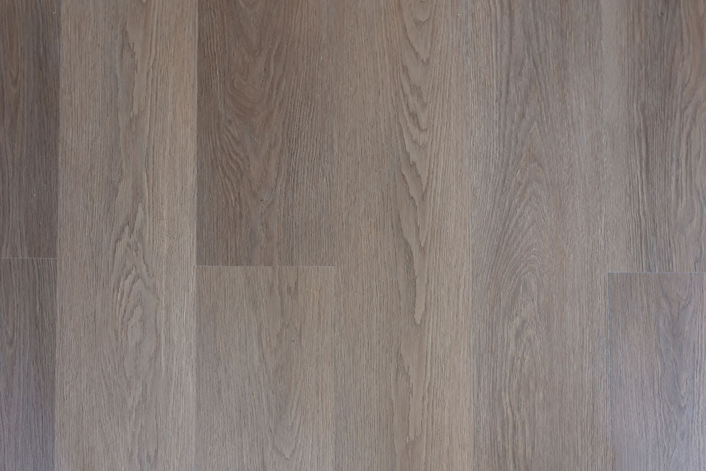 Close-up of a vinyl click oak effect floor with brown and grey tones