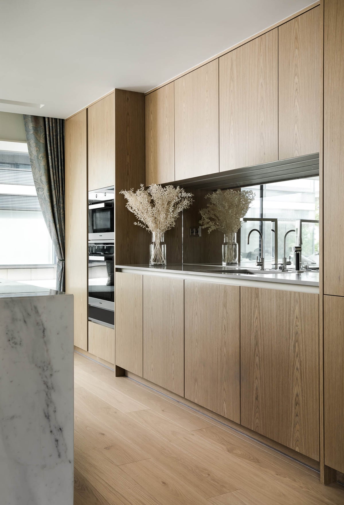 Oak kitchen cabinetry with oak flooring