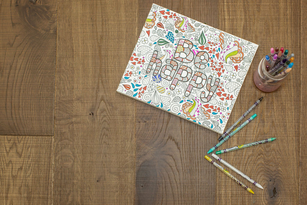 Colouring in book sitting on urban nature shadow grey engineered wood floors