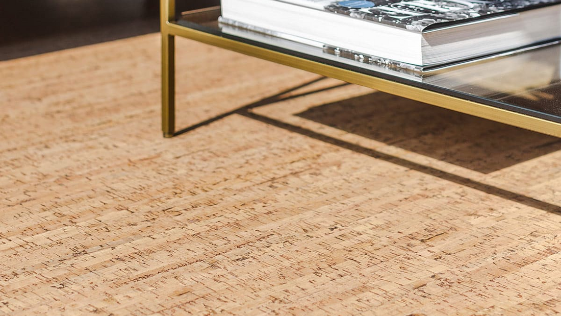 Cork floor with a glass coffee table and books in the background