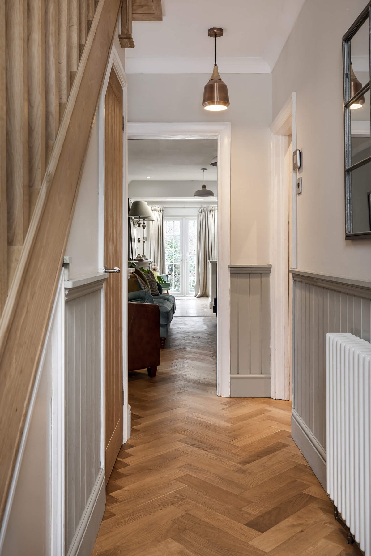 hallway with herringbone wood floors