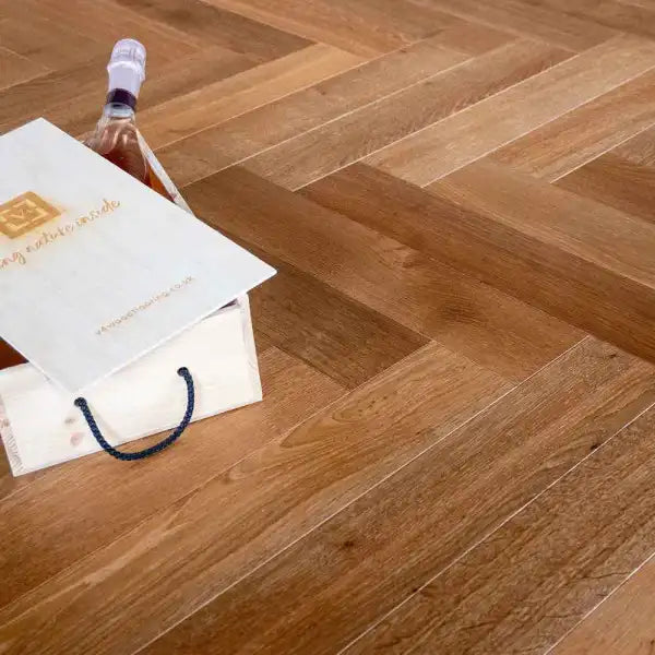 tundra extra large thermo oak herringbone floors with a bottle and packaging on top