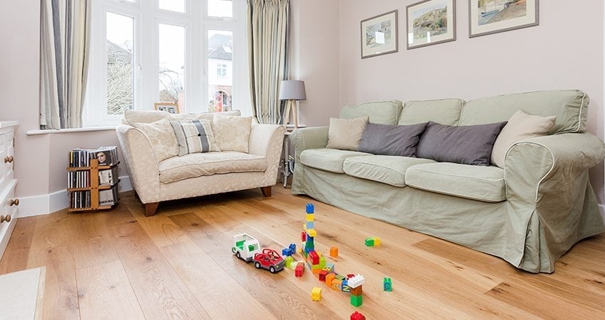 light oak wood flooring in a living room with plastic toys in the foreground