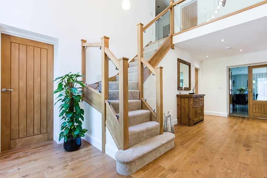 golden oak wood floors with a wooden and carpeted staircase