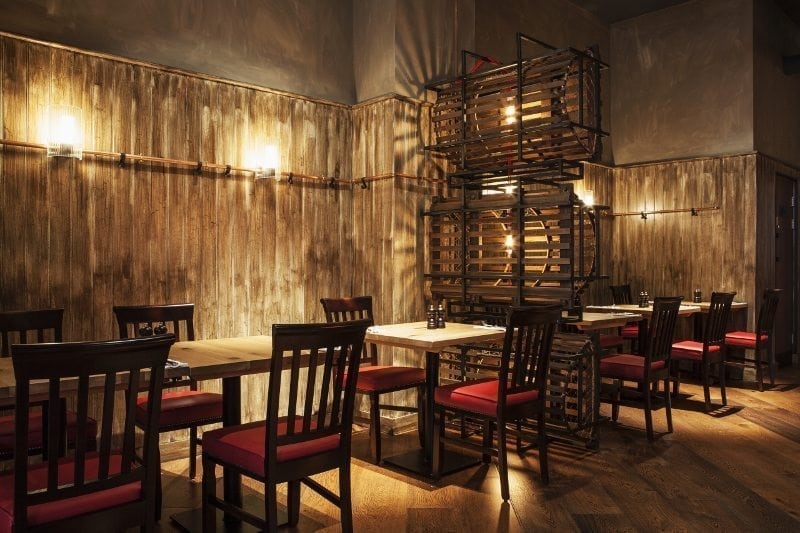 trendy interior lighting and oak wood floors in a Burger & Lobster restaurant