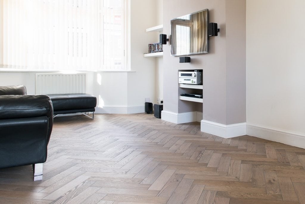 Herringbone parquet floor in a modern living room with natural light