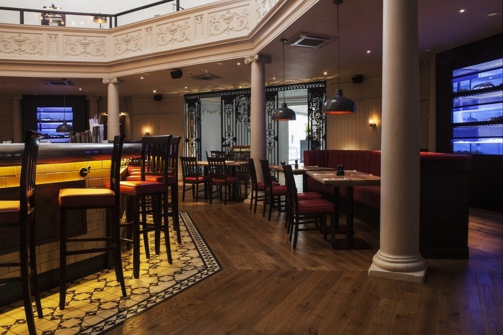 Dark oak wood floors in a Burger & Lobster restaurant