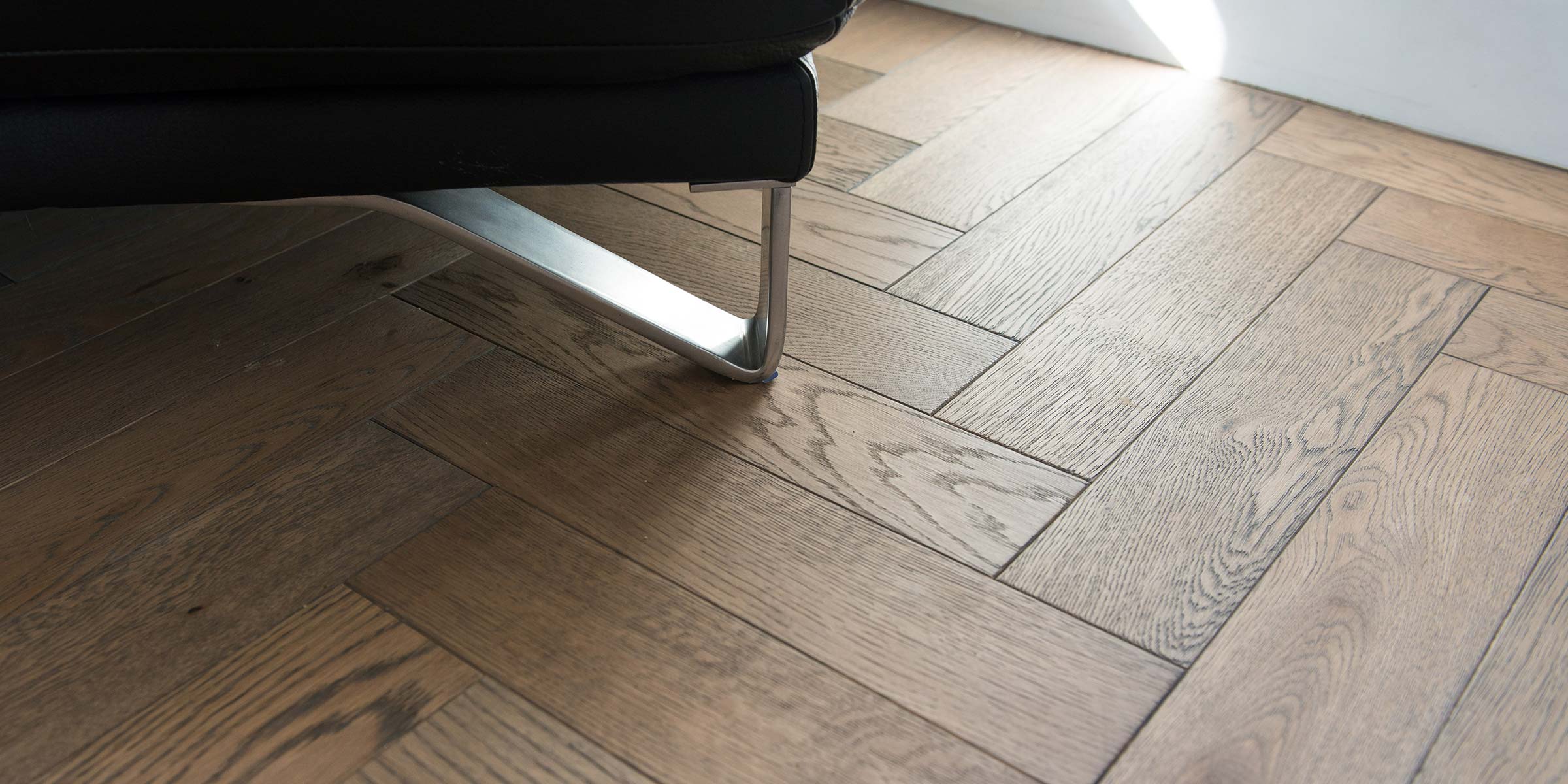 close up of engineered wood parquet blocks in a herringbone pattern