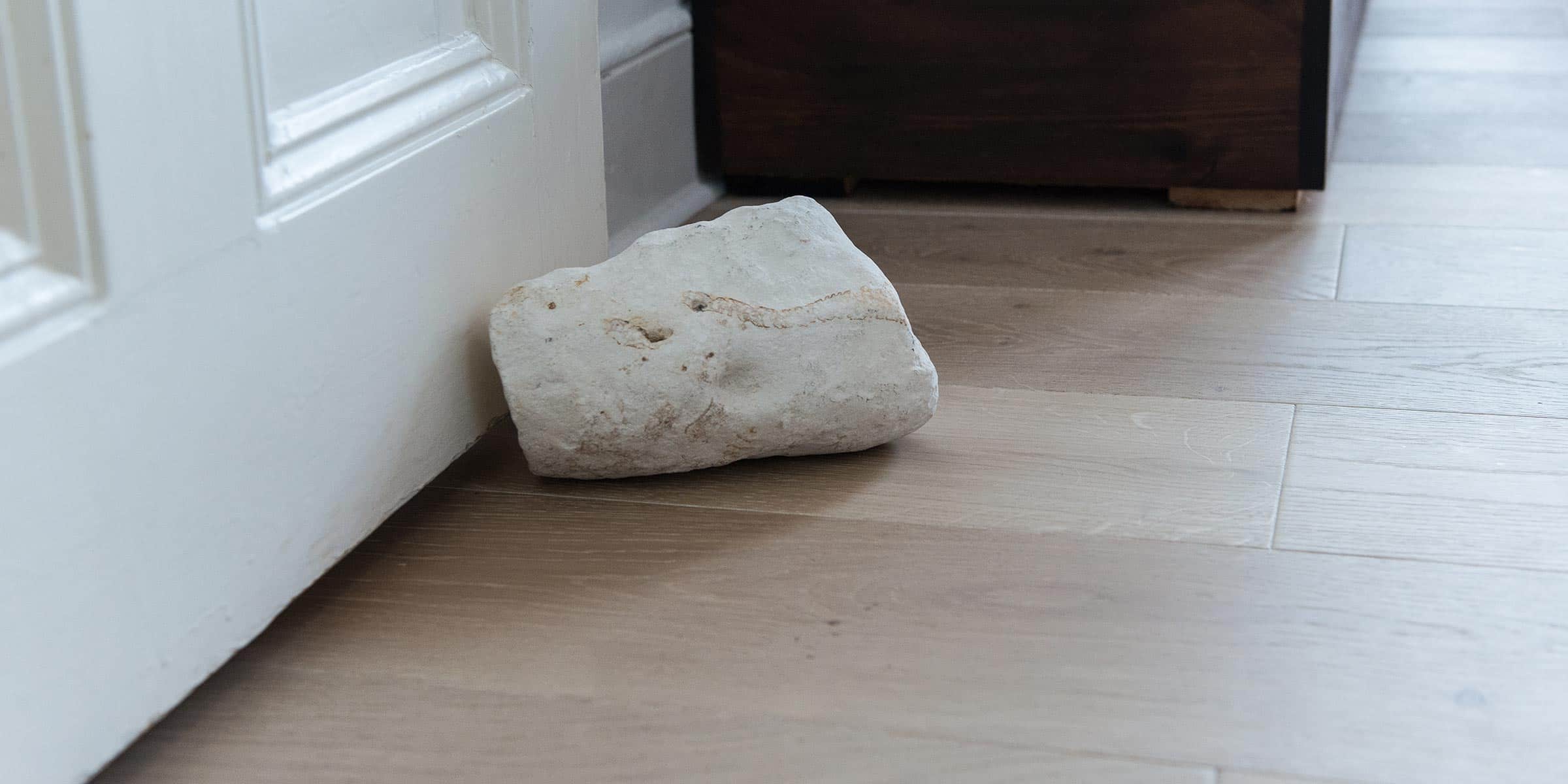 nordic style light wood flooring with a rock door stop