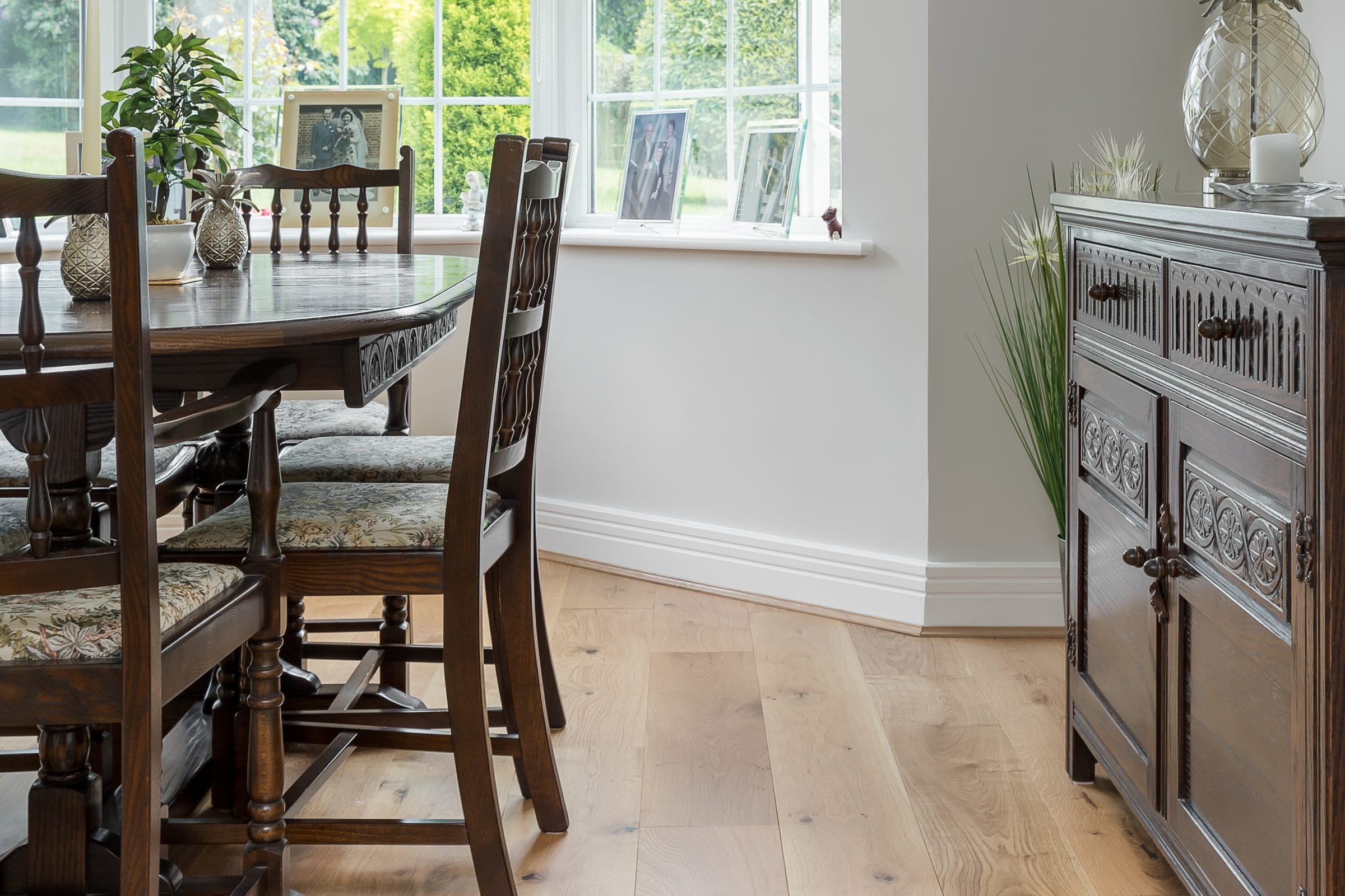 light oak wood floors with darker wood dining room furnishings