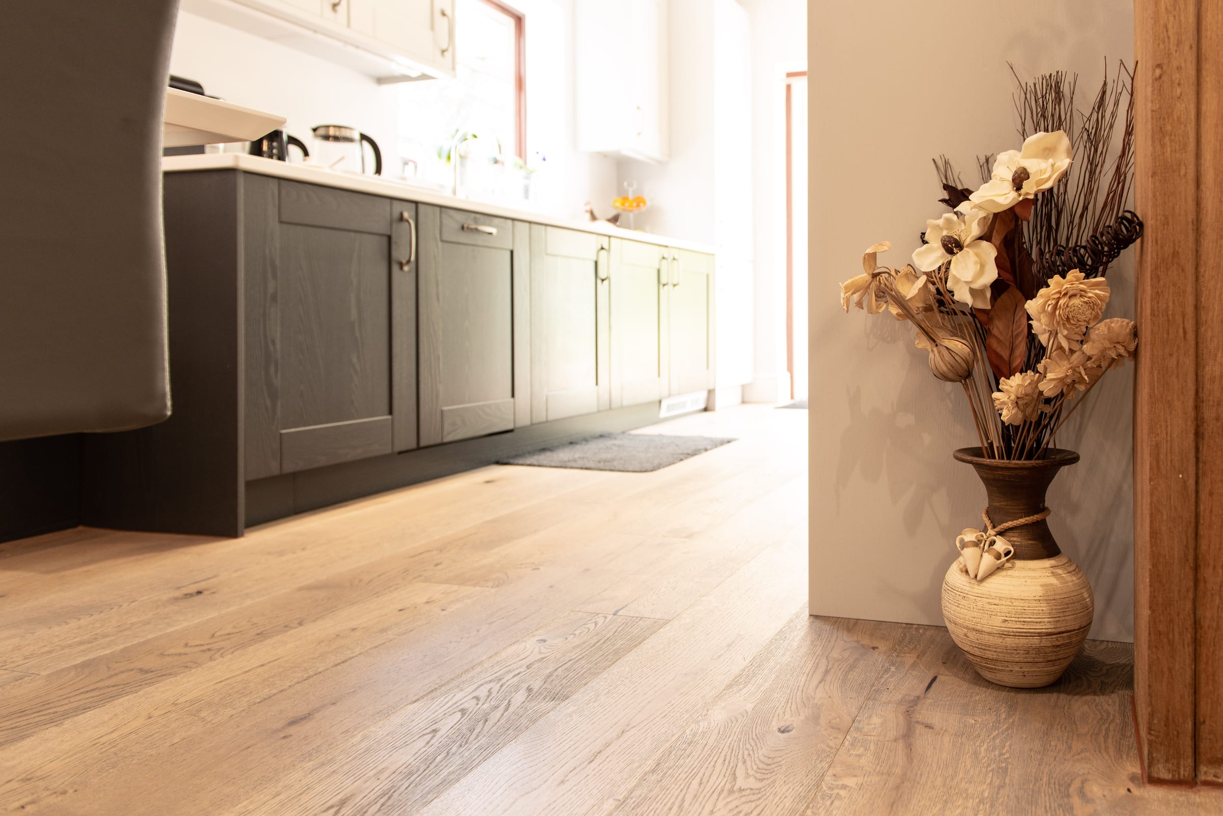 mid tone frozen umber wood flooring in a sunny kitchen