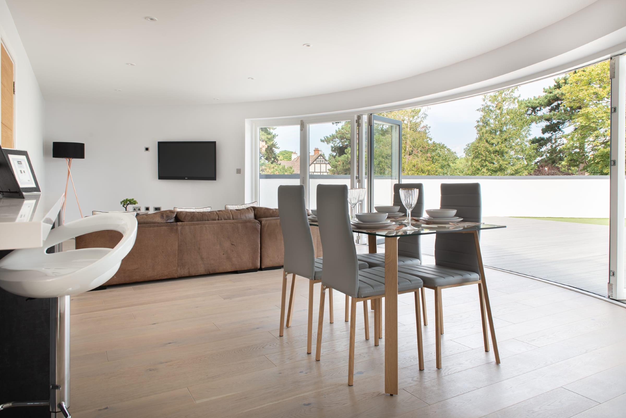 warm toned wood flooring with a dining room table and chairs