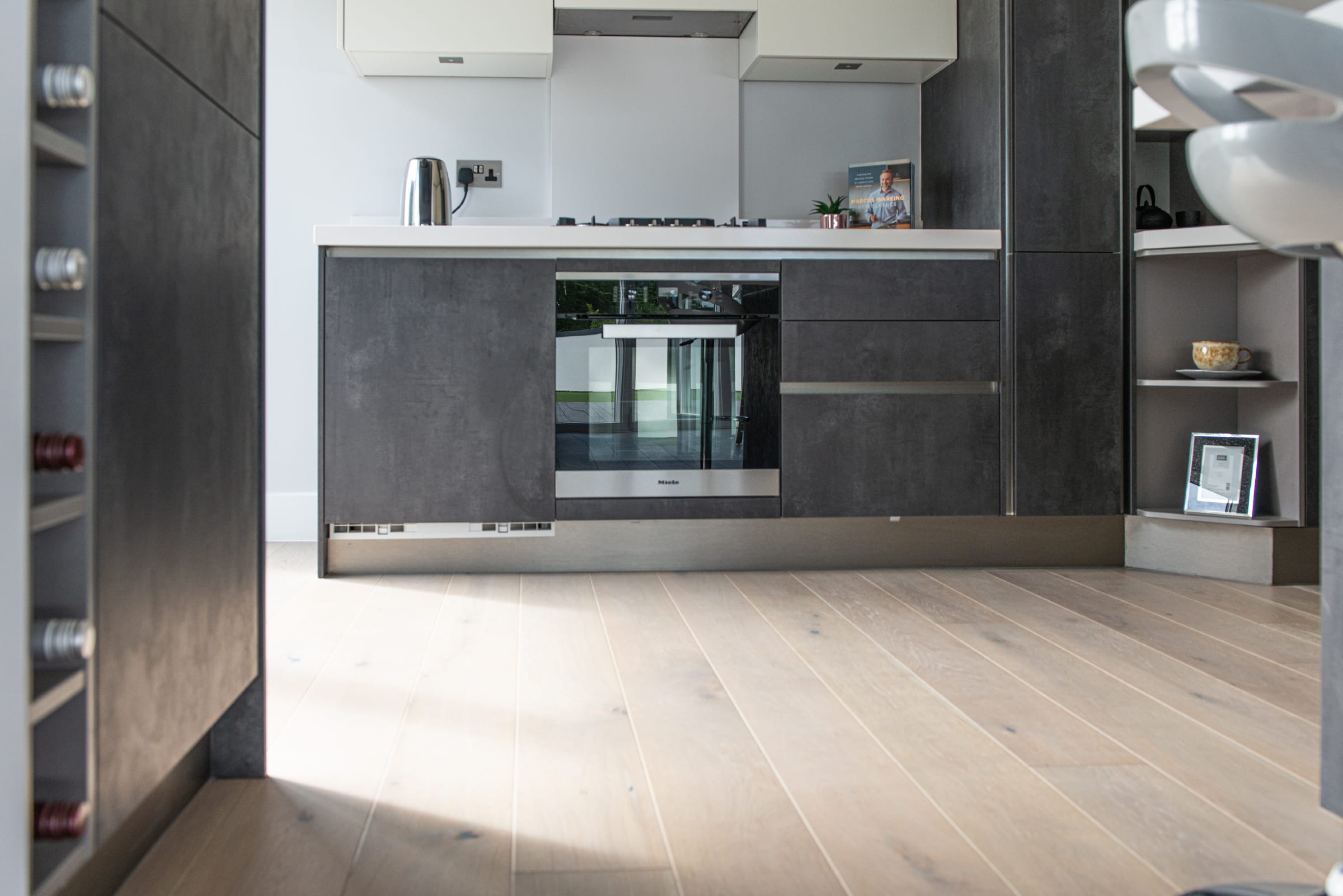 modern slate grey kitchen with light wood flooring