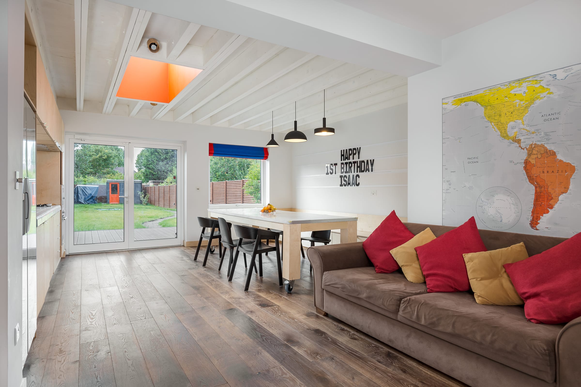 open plan house with dark wood floors and colourful furnishings