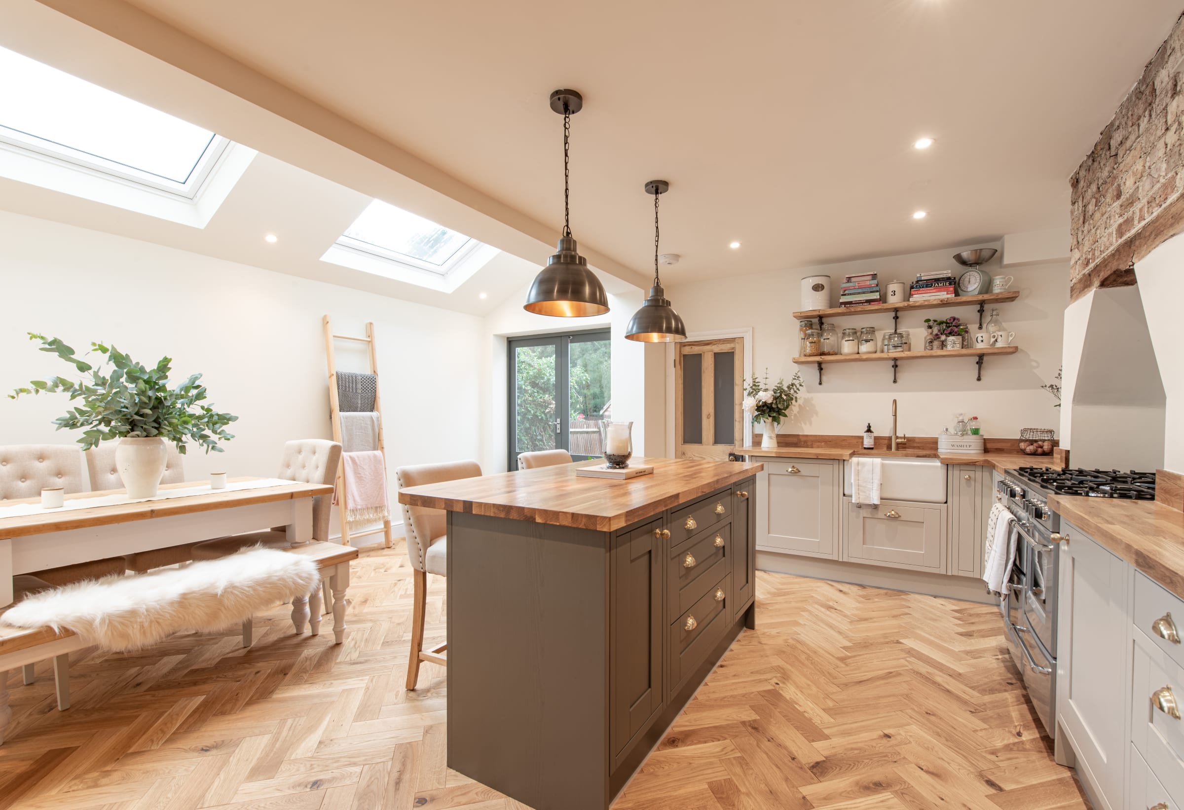 full view of a modern kitchen with herringbone wood floors