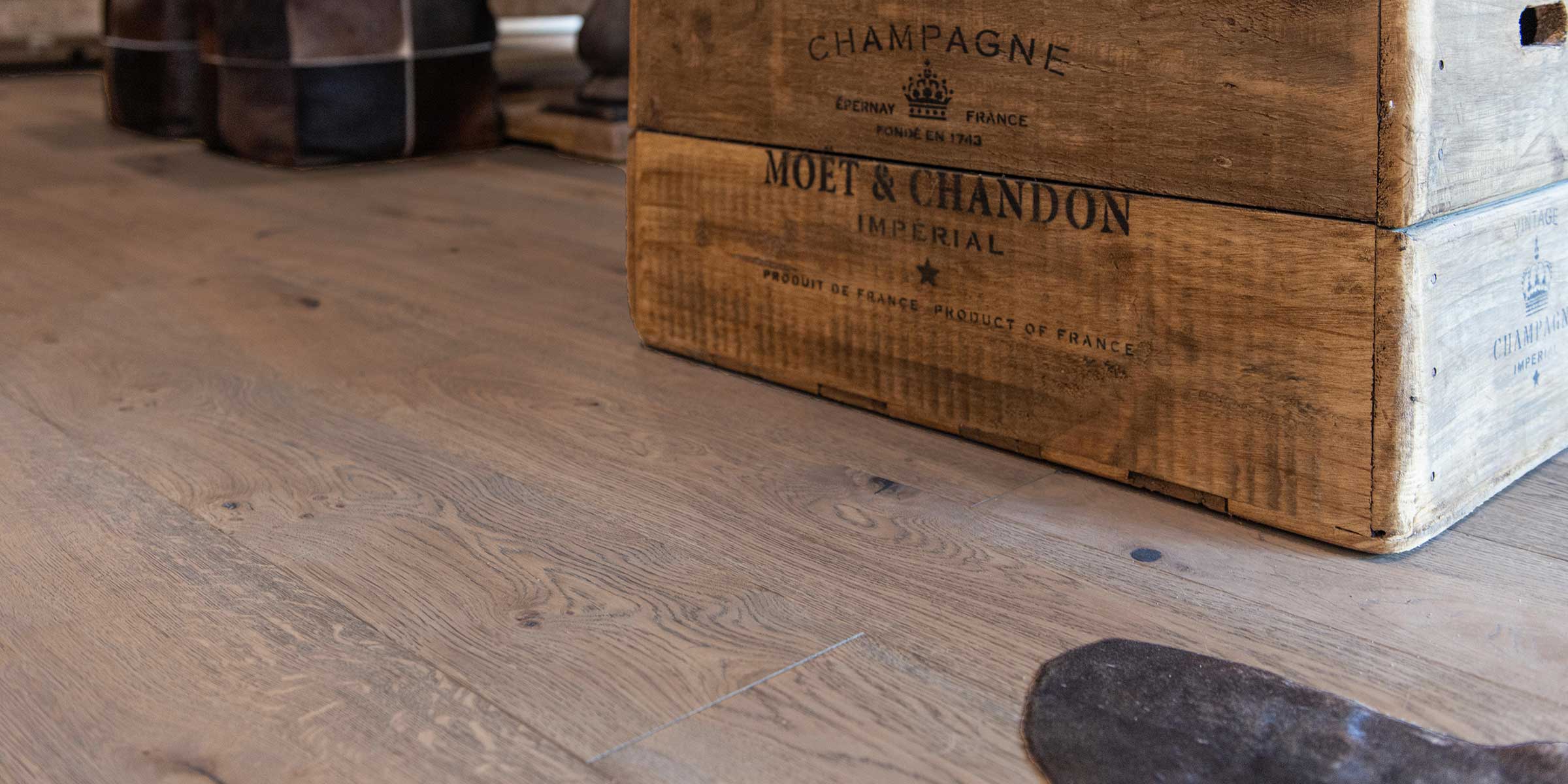 frozen umber wood flooring with a Moet and Chandon champagne case