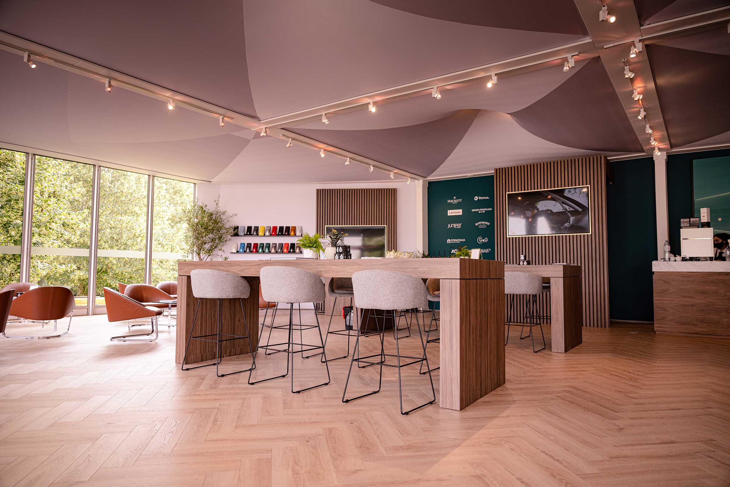 oak floor in a common room with leather chairs and bar stools