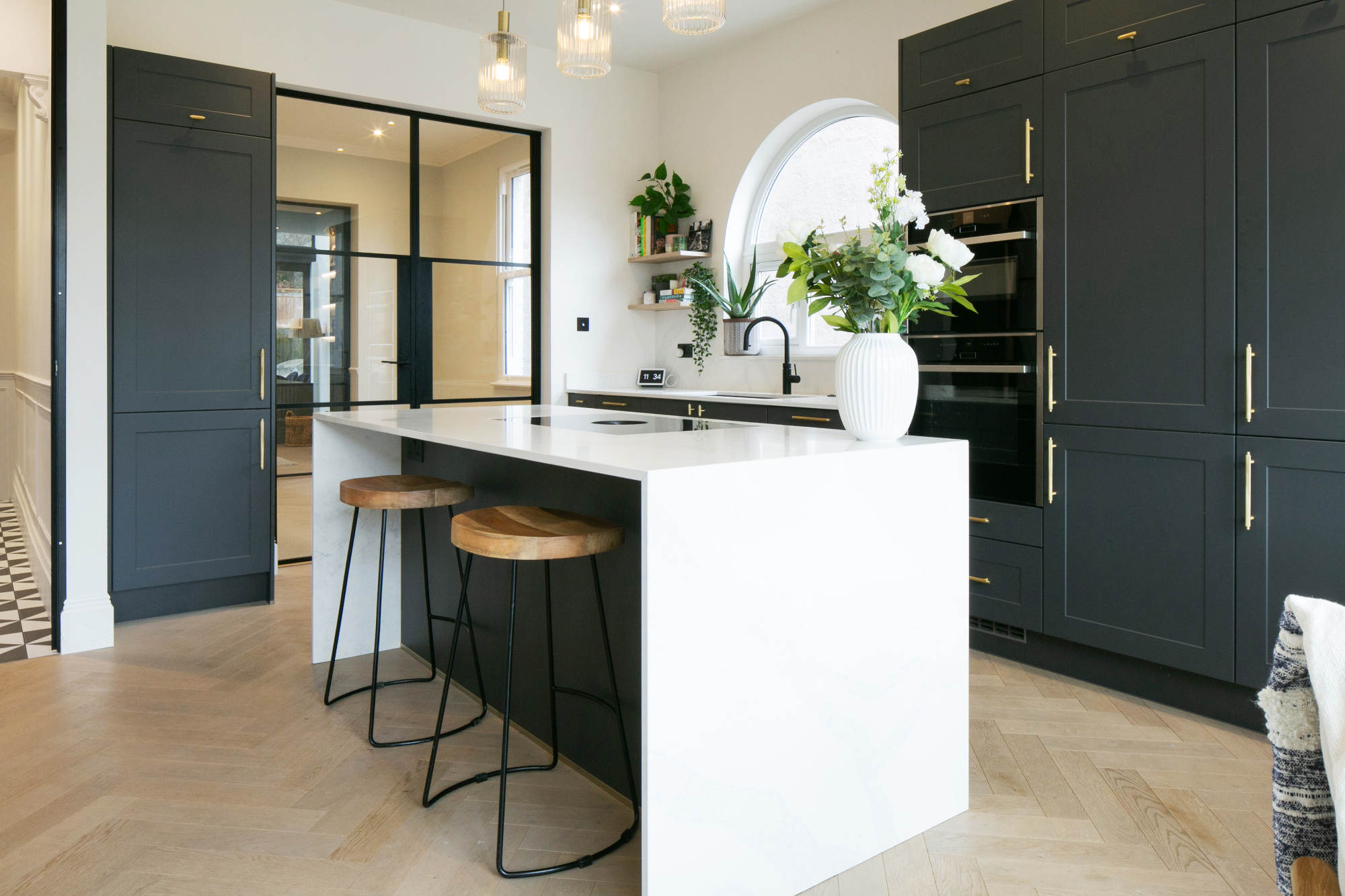 a fully installed kitchen with white marble counter tops