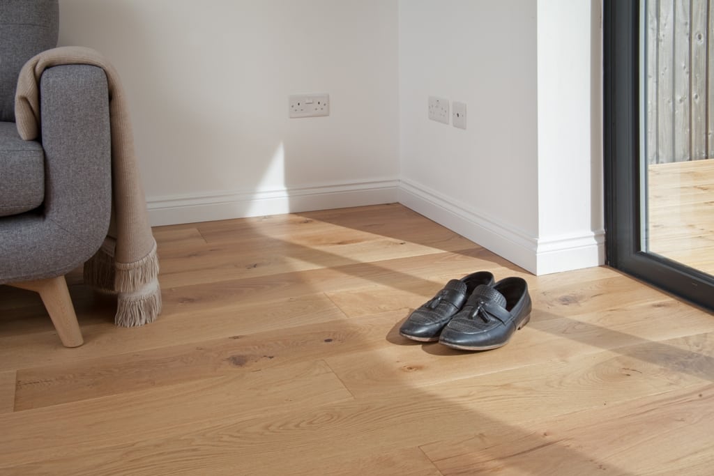 close up of oak wood floors with a pair of shoes