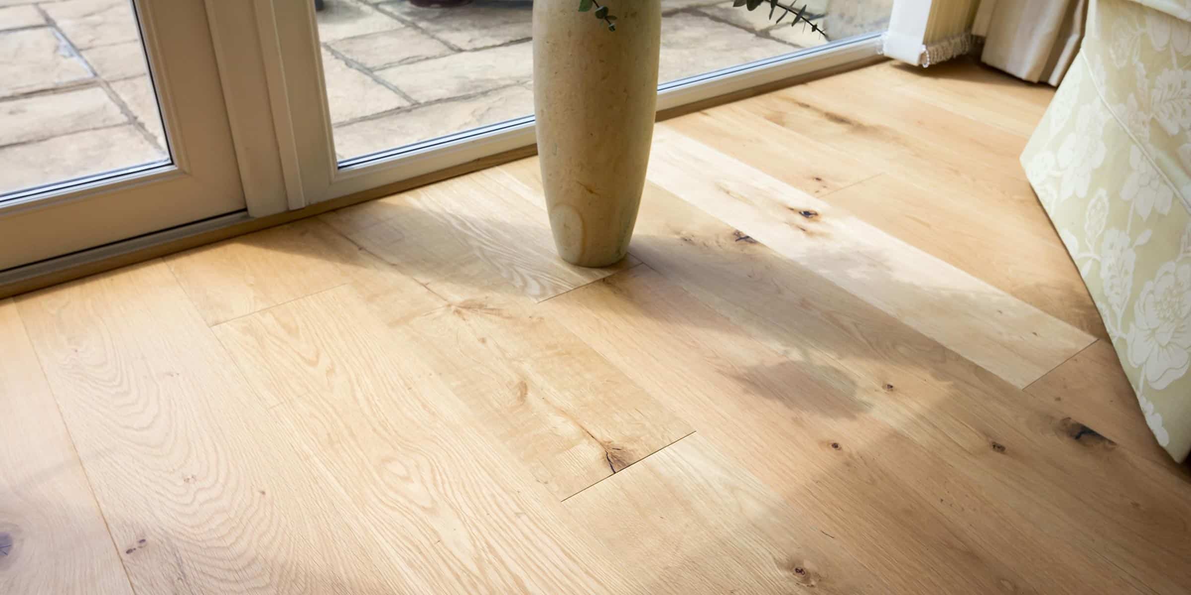 close up of oak wood flooring looking out on a sunny patio