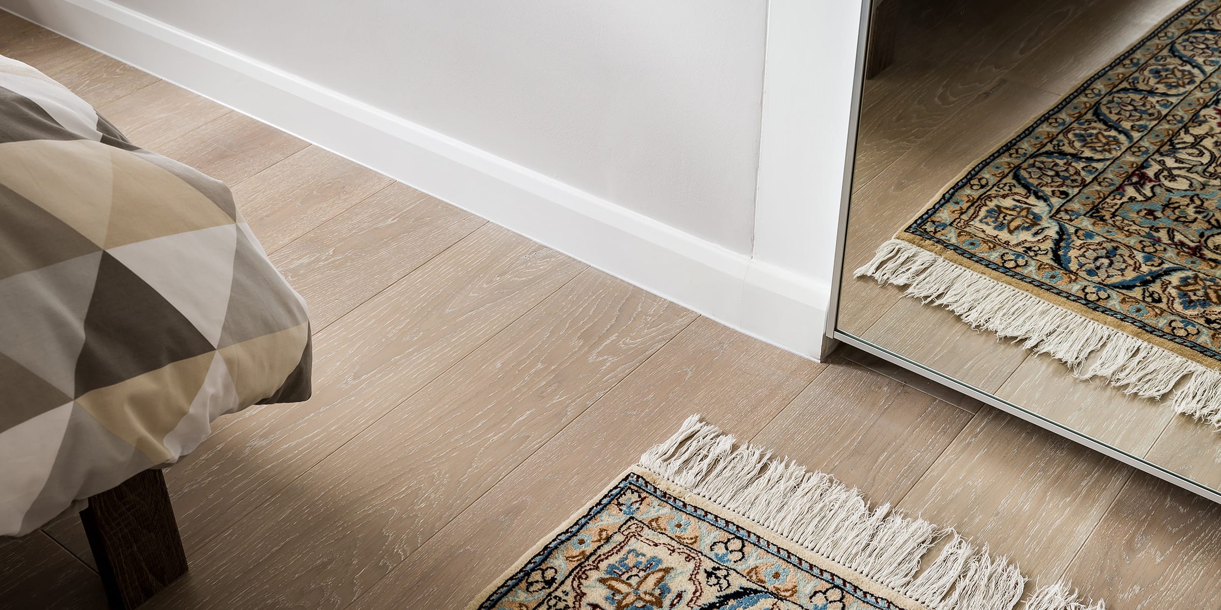 close up of silver sands wood floors with a small carpet