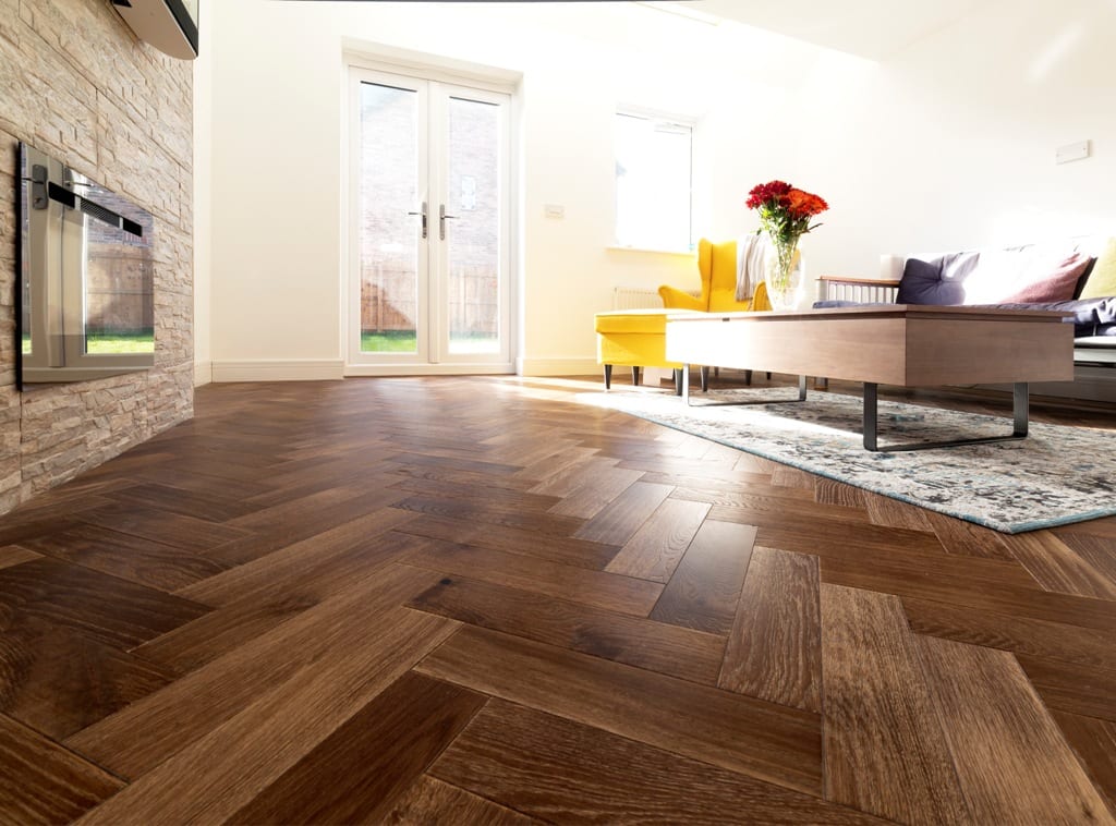 herringbone wood floor in a sunny living room