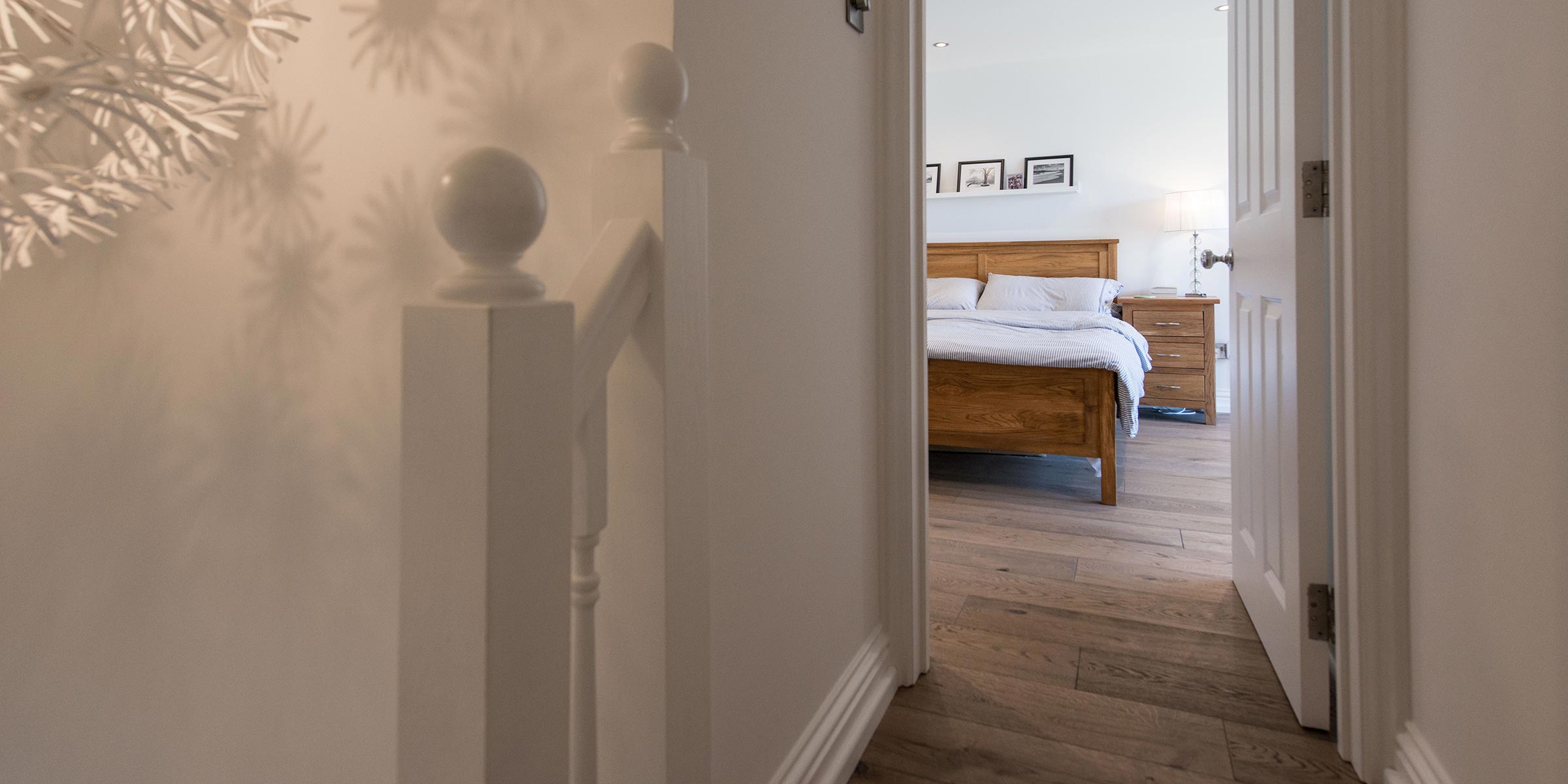 view of a bedroom from the hallway featuring frozen umber wood flooring