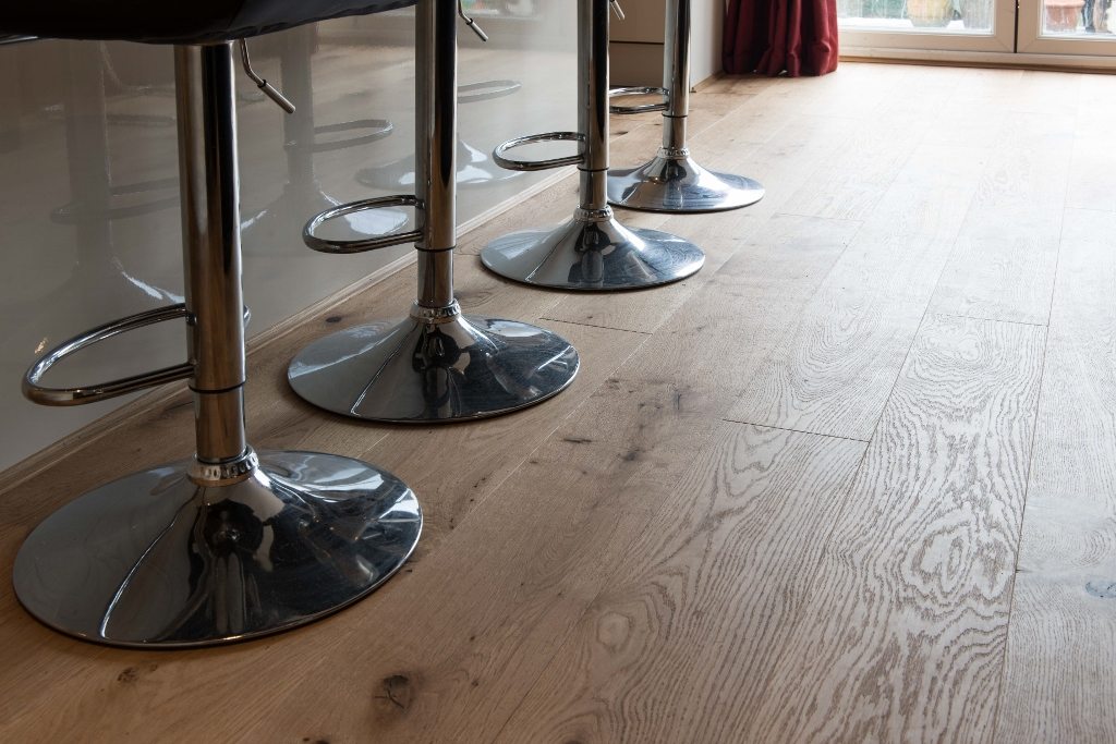 metallic bar stools on hard wood flooring