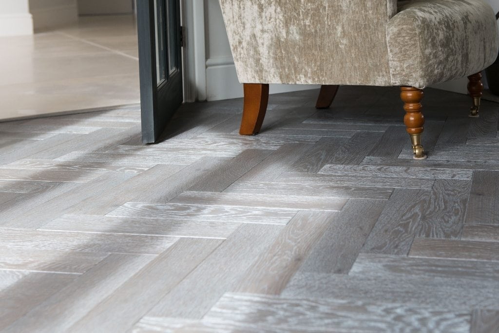 close up of light grey herringbone wood flooring