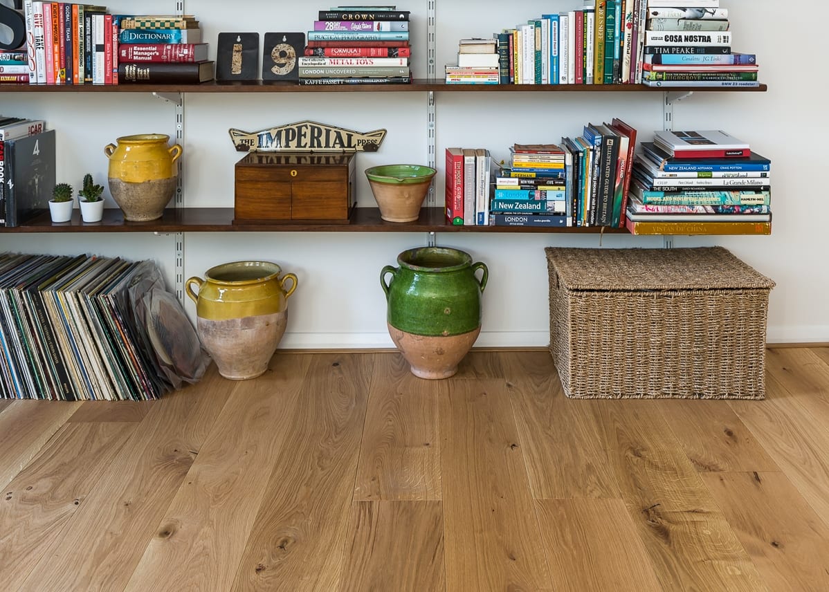 oak wood floors and a bookshelf with ceramic pots